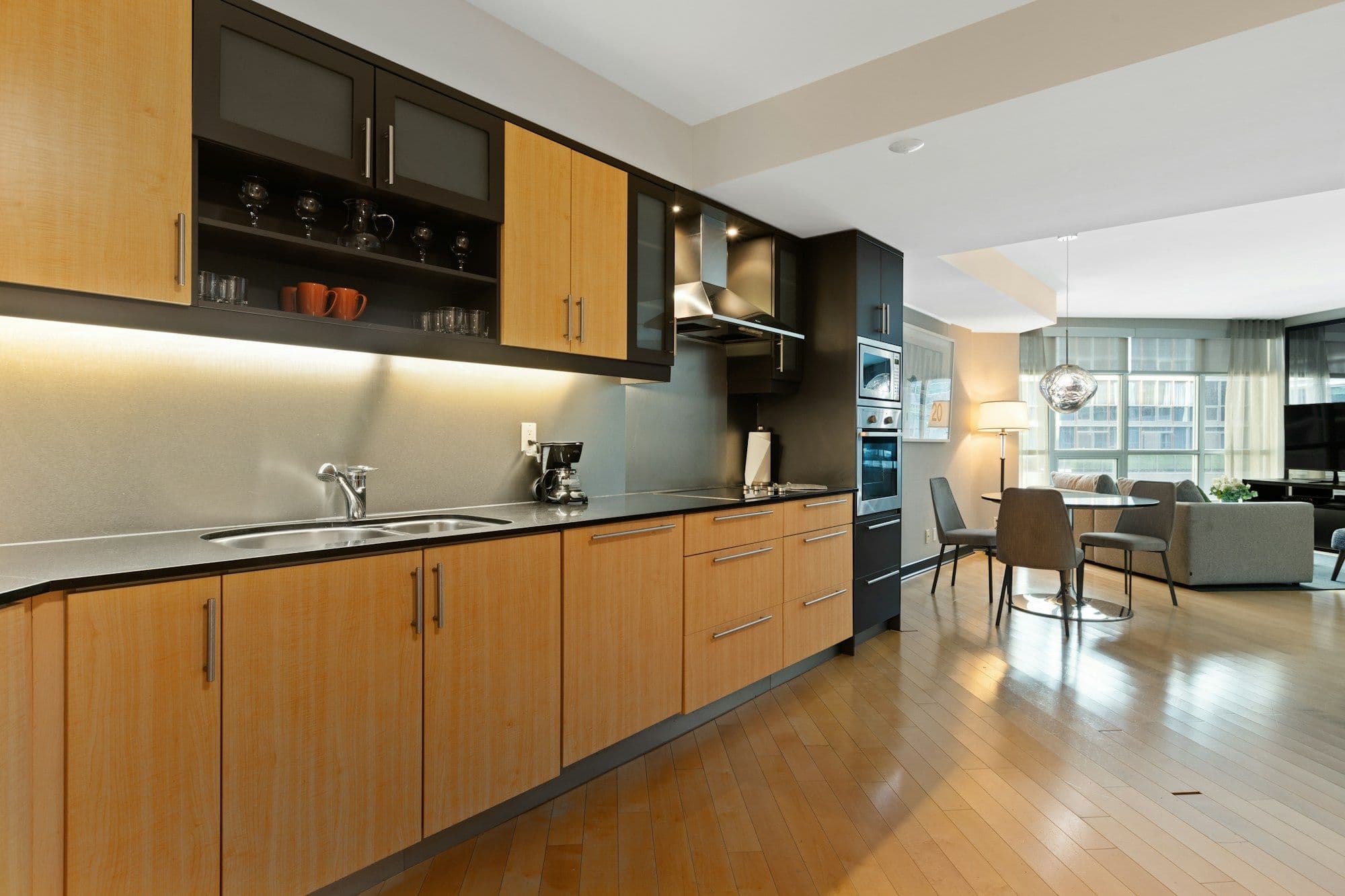 Custom oak veneer and matte lacquered kitchen cabinetry after substrate-matched formaldehyde treatment.