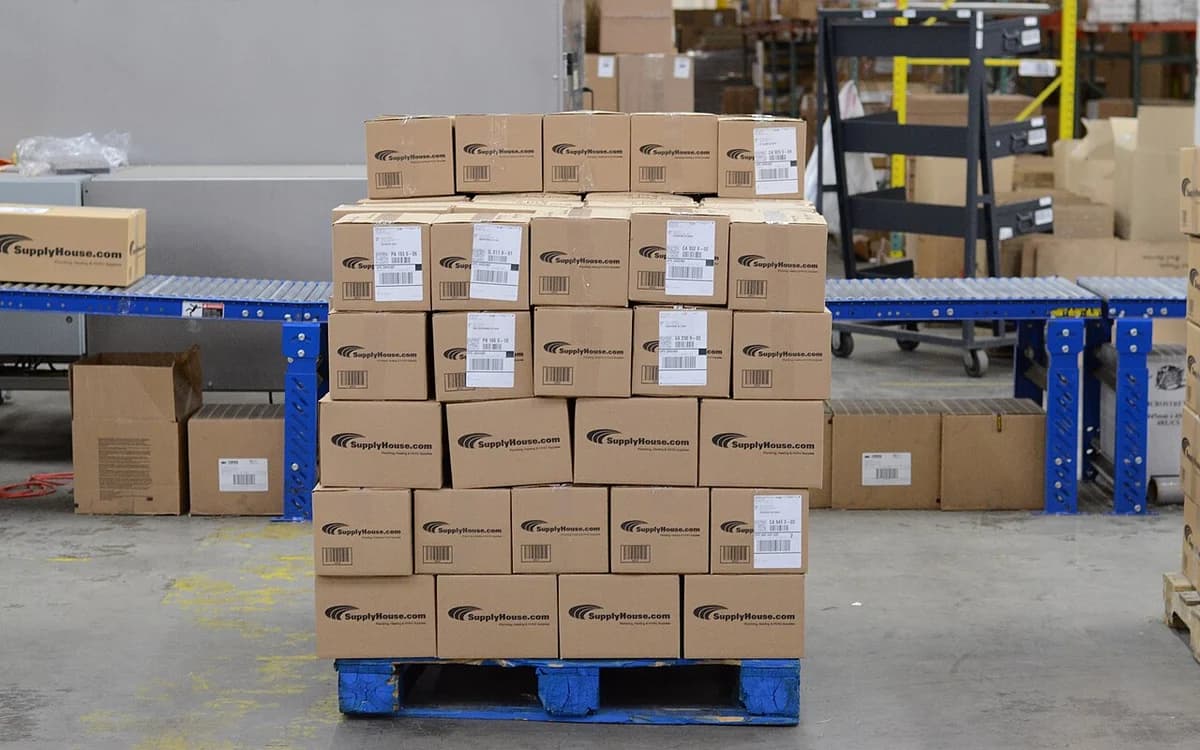 E-commerce fulfillment warehouse cardboard parcels on conveyor belt