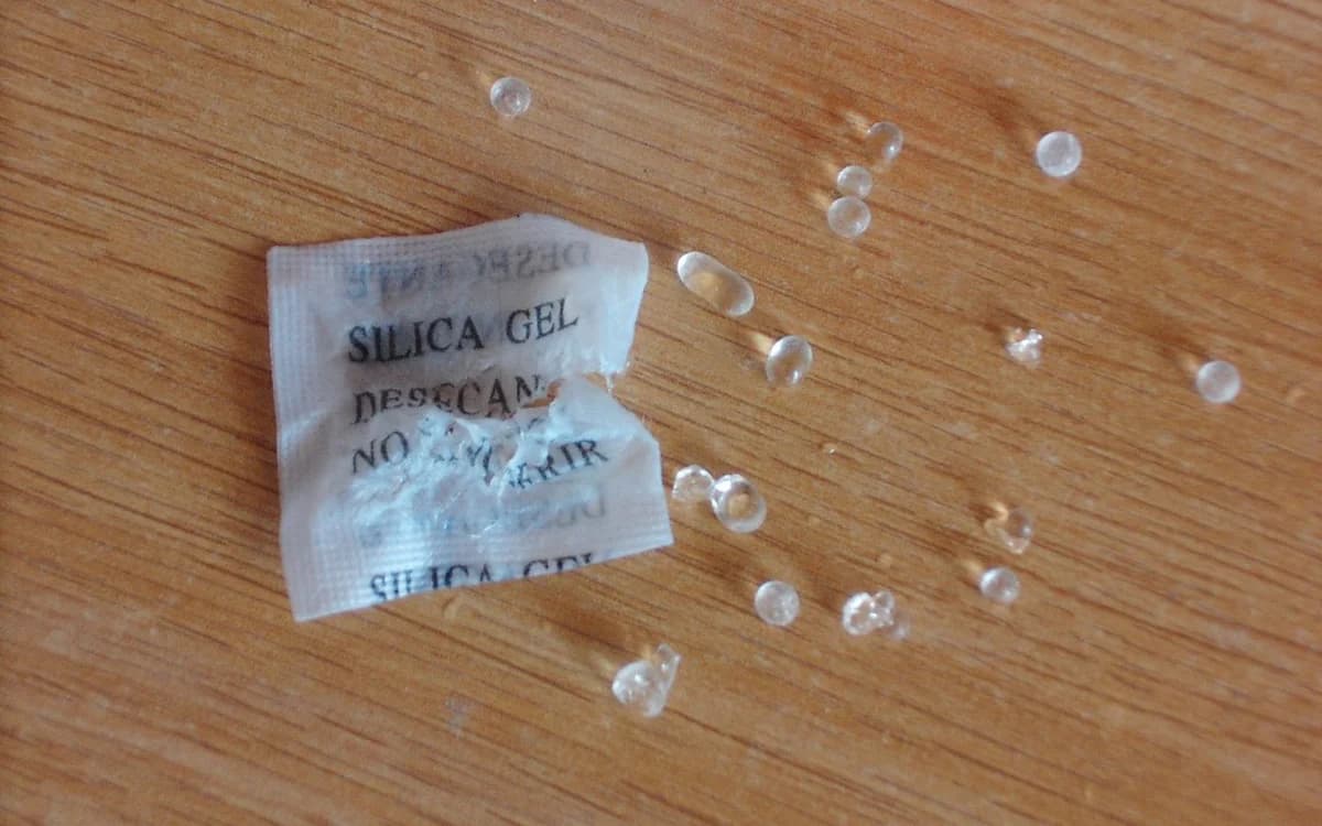 Breathable non-woven adsorbent bag opened to show internal granules