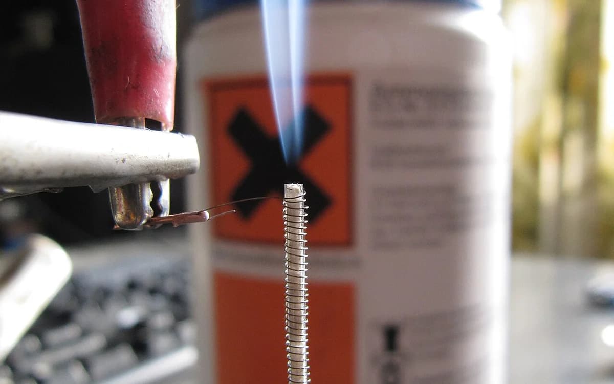 White crystalline ammonium chloride salt efflorescence reforming on a dark substrate surface