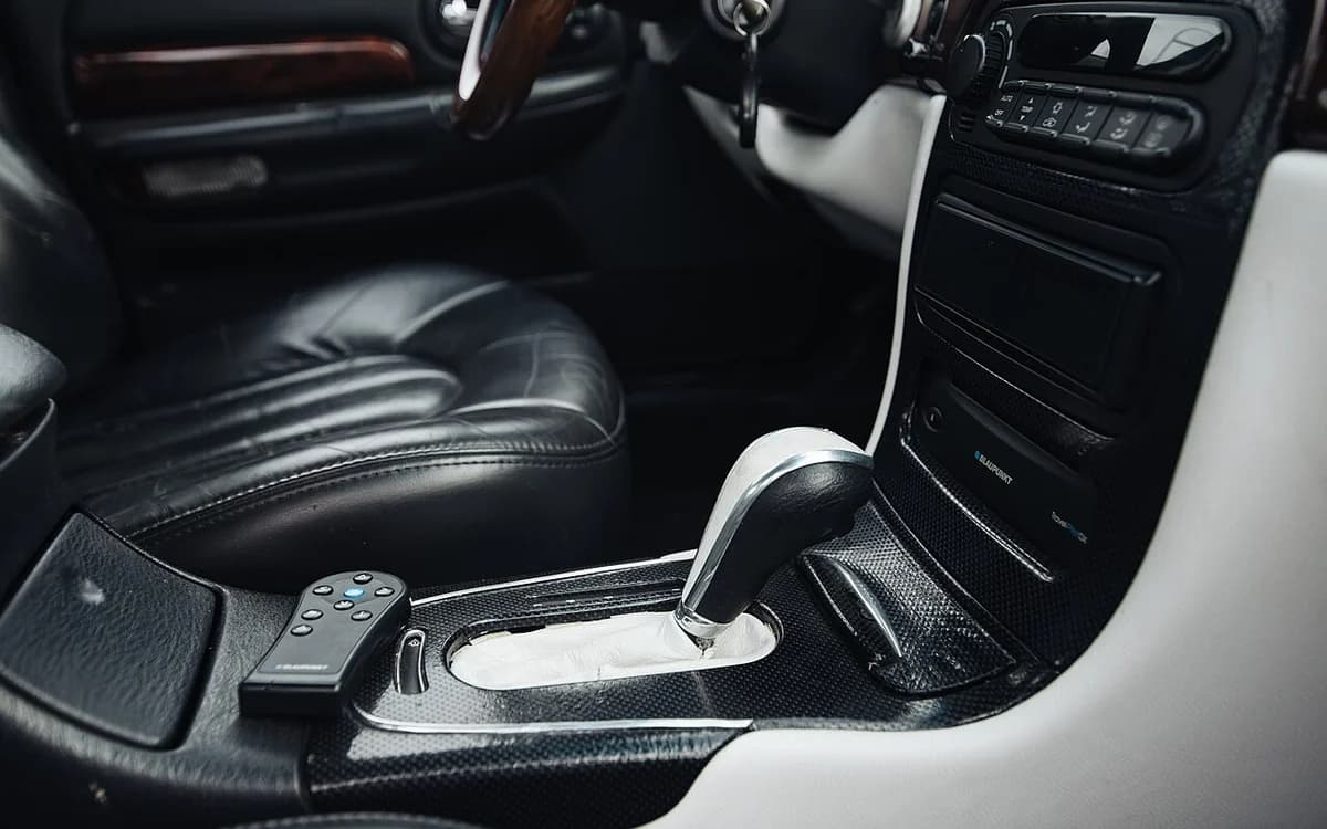Modern passenger vehicle cabin interior showing center console, gear shift, and dashboard trim
