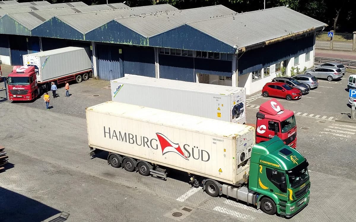 Stacked refrigerated shipping containers at a maritime port terminal