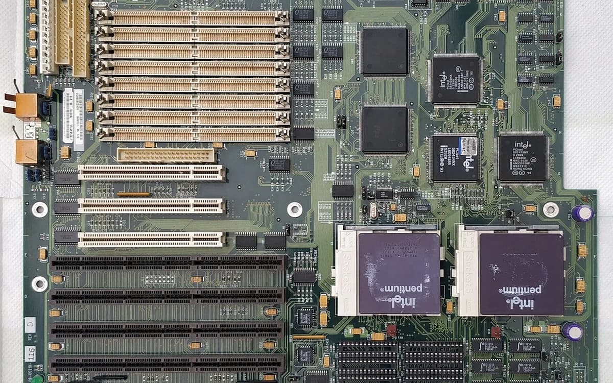 Close-up of server motherboard copper circuit traces and gold-plated PCIe contact pins