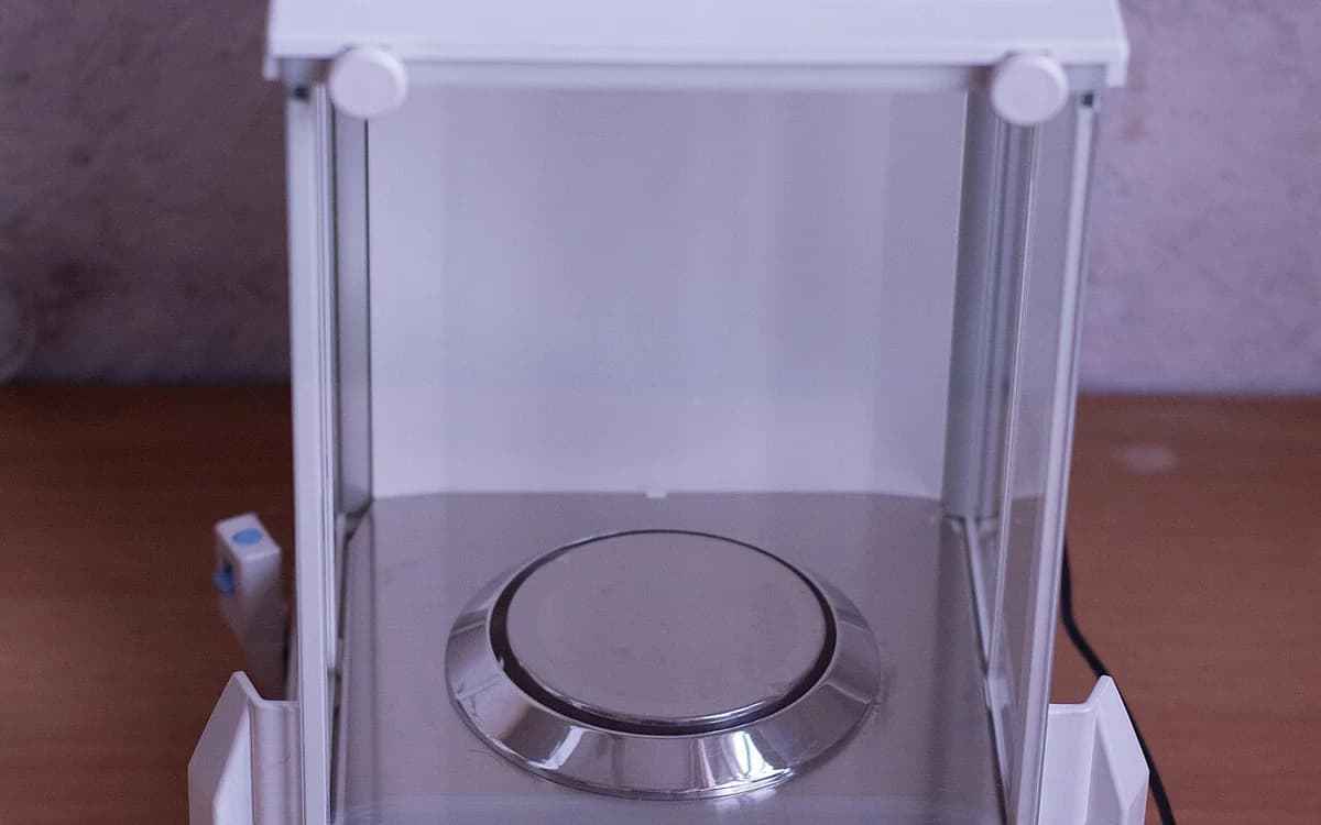 Precision analytical balance inside a quality-control chemistry laboratory