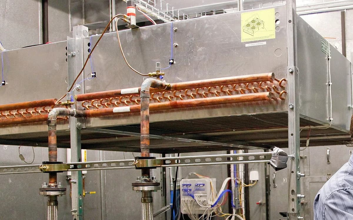 Commercial HVAC fan-coil unit assembly with blower motor and heat exchange housing