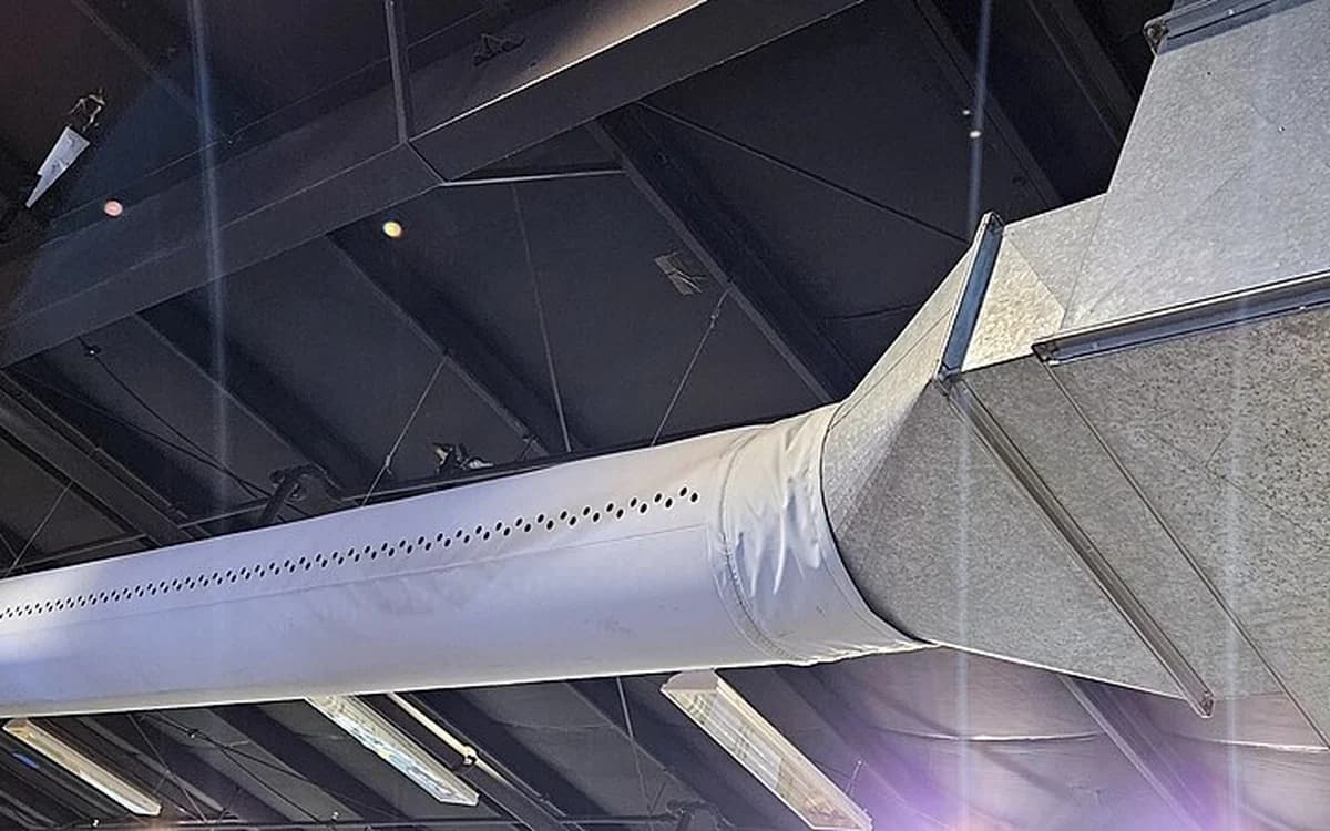Overhead galvanized sheet-metal HVAC air supply ductwork in a commercial building