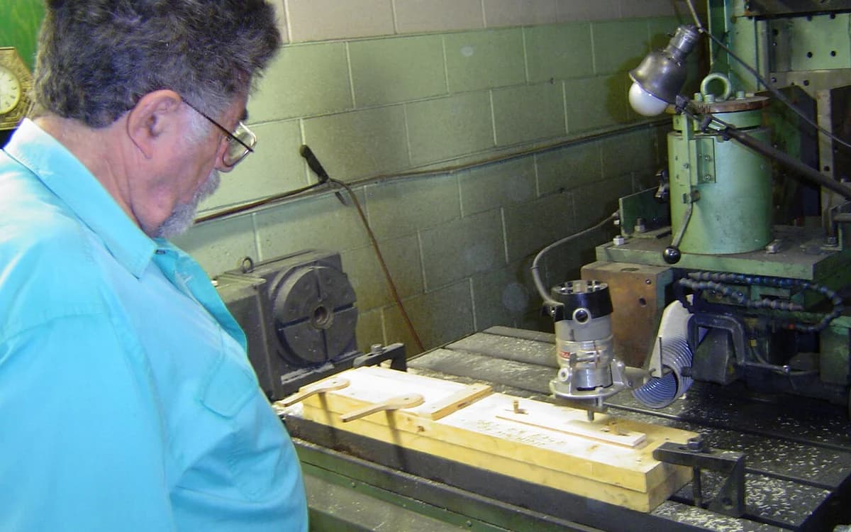 Industrial CNC wood router machining a conditioned composite wood panel in a furniture plant