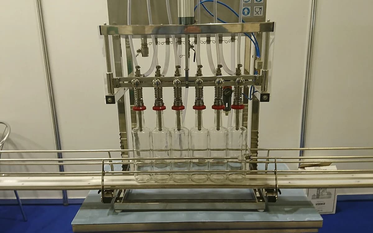 Automated commercial liquid bottling and filling line in a production plant