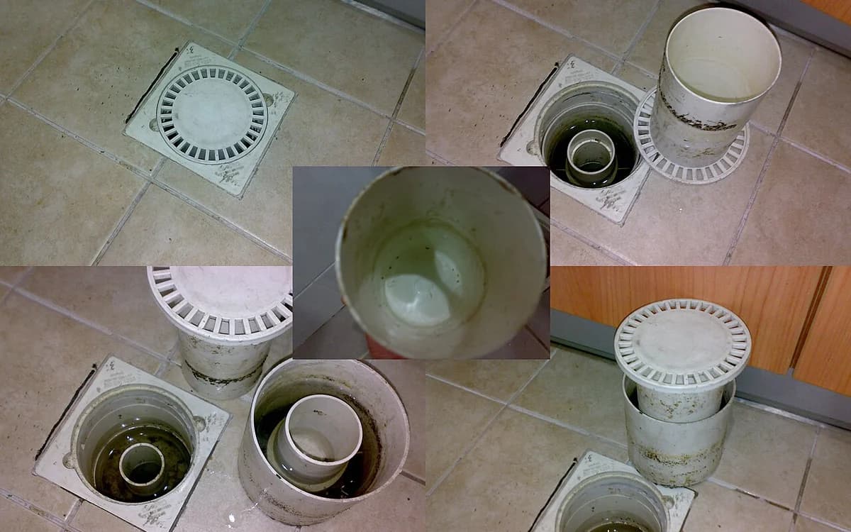 Commercial stainless-steel floor drain cover with water trap in a tiled restroom