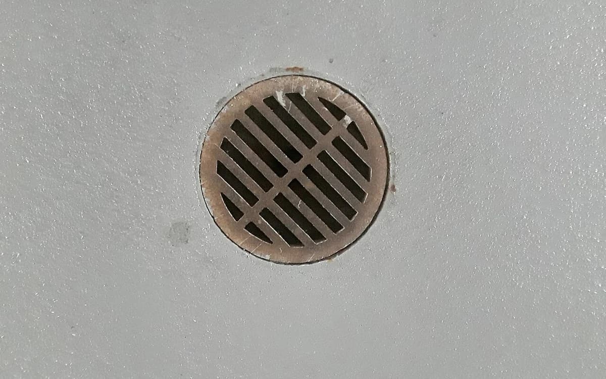 Underground concrete basement garage floor with drainage channel