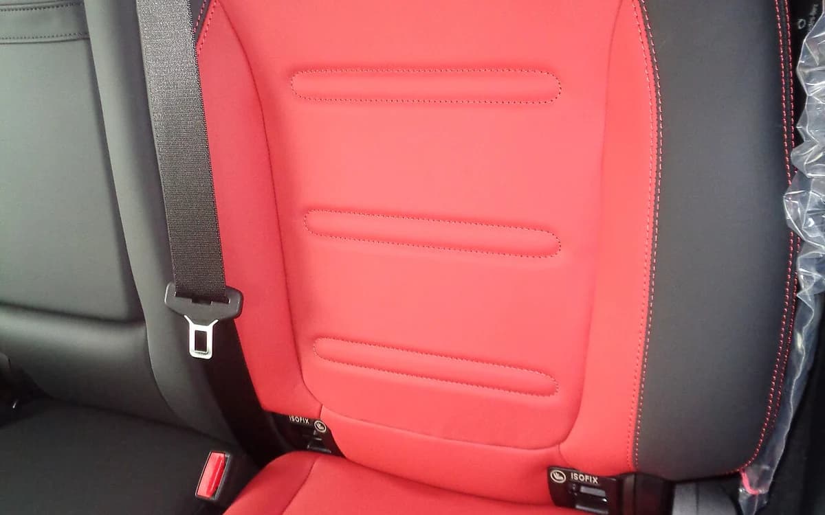 Two-tone luxury sedan cockpit with perforated leather seats and suede trim