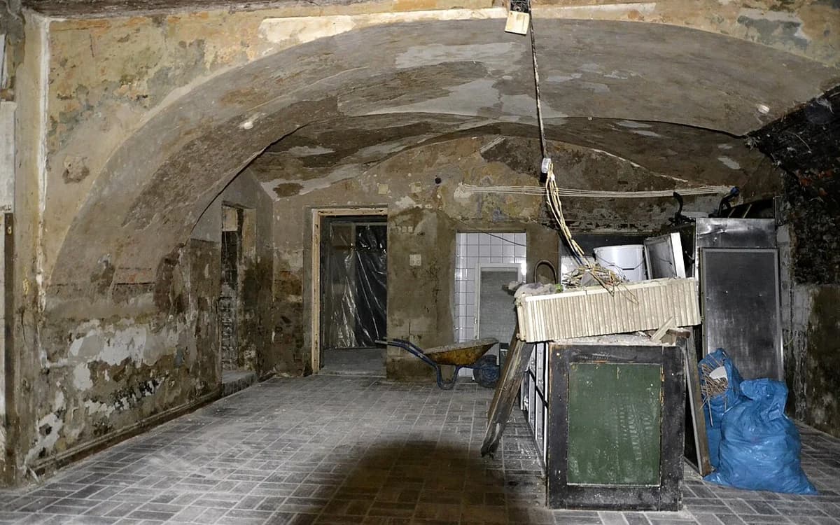 Flood-damaged interior room undergoing water extraction and structural drying