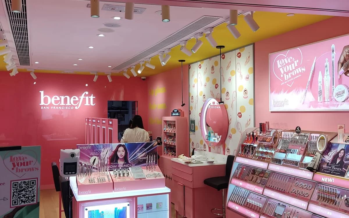 Cosmetics retail boutique interior with illuminated display cabinets and shelving