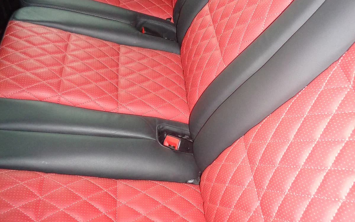 Automotive fabric roof headliner and cloth headrest upholstery in a passenger car