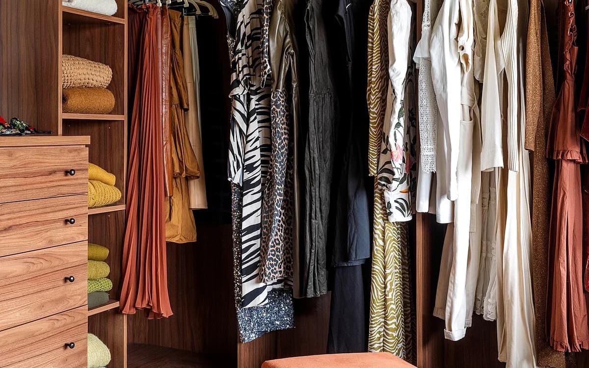 Enclosed closet shelves filled with folded textiles and garments