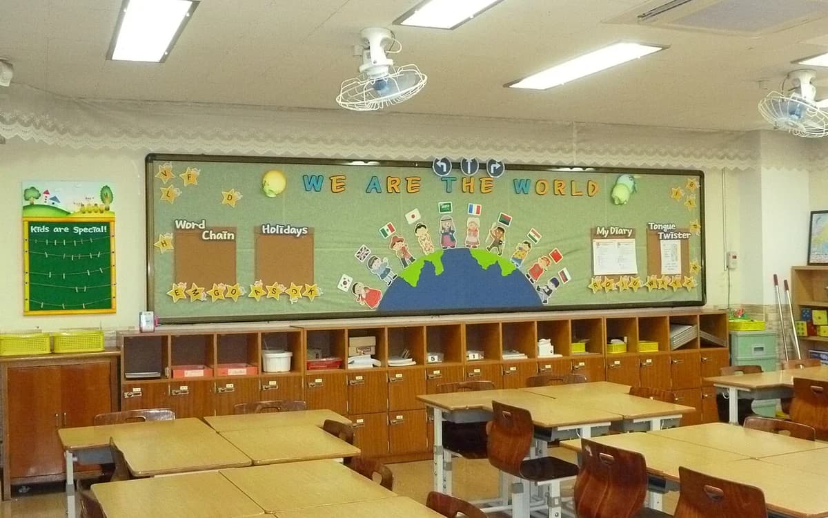 School classroom filled with rows of wooden student desks and chairs