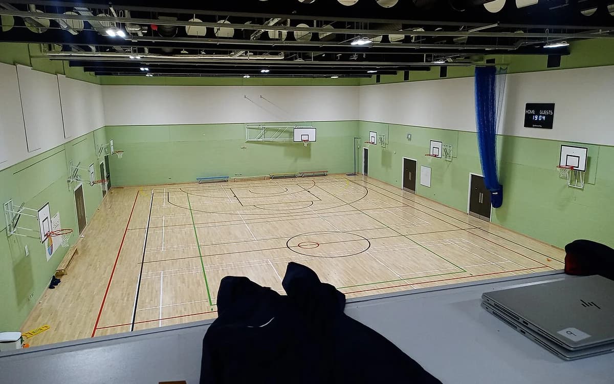 School indoor gymnasium and auditorium hall with high ceiling and acoustic wall panels