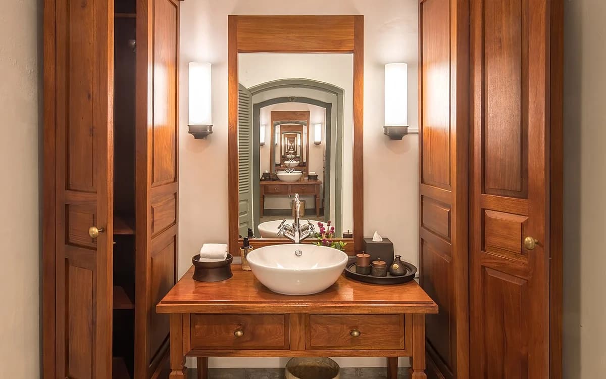 Luxury walk-in wardrobe and dressing room lined with custom wooden cabinetry
